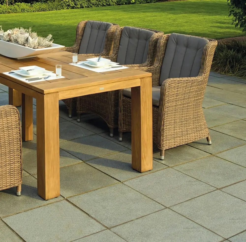 Construction of natural stone patio with integrated seating areas
